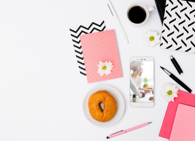 Smartphone mockup with breakfast in office