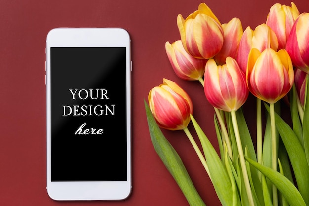 Smartphone mockup with tulips on claret background Device screen mock up for presentation or appl design