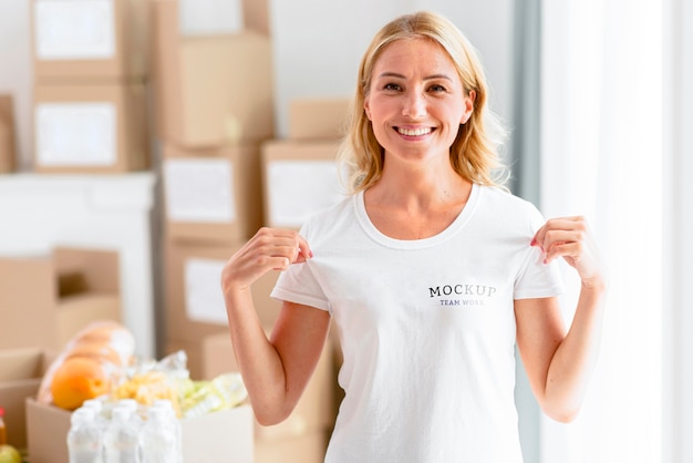 Smiley female volunteer holding her t-shirt