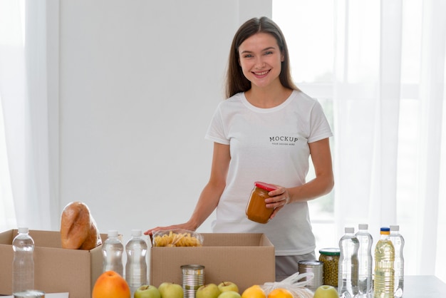 Smiley female volunteer preparing food for donation