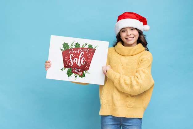 Smiley girl holding paper sheet with sales message