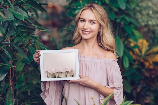 Spring concept with woman holding tablet mockup