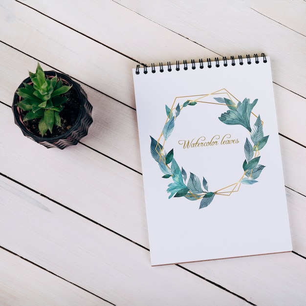  spring notebook mockup with decorative plant in top view