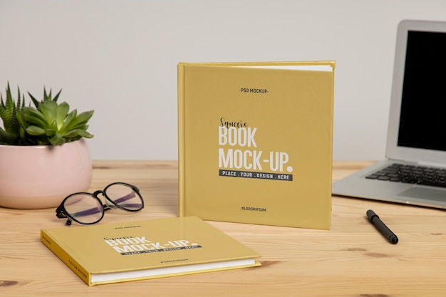 Square book mock-up on wooden office desk