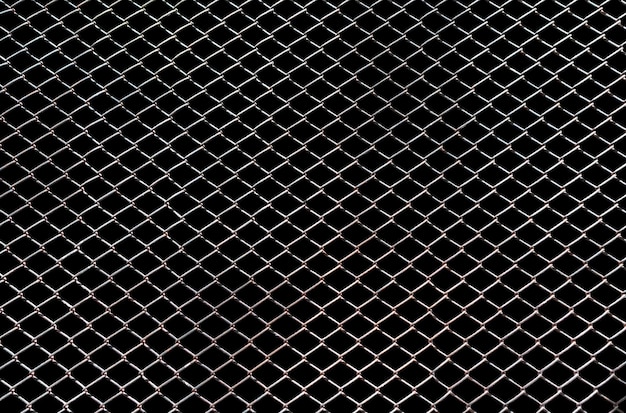 Steel mesh wire fence isolated on black background with clipping path