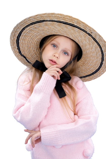 Studio portrait of young girl with straw hat