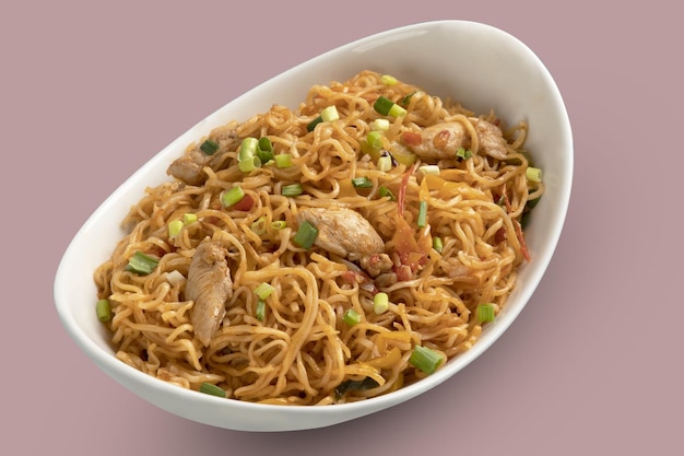 A stylish bowl of chicken noodles with onion