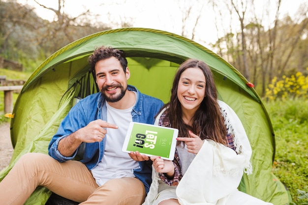 Summer camp mockup with couple pointing at tablet