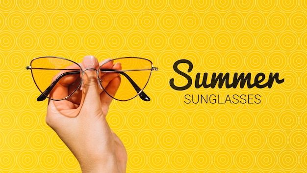 Summer fashion sunglasses held in hand