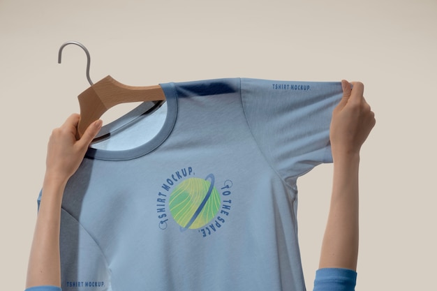 T-shirt mock-up held by human hands