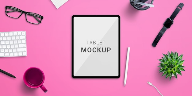 Tablet mockup on pink office desk. Scene creator with isolated layers. Top view, flat lay composition