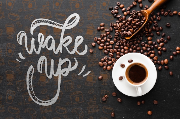 Tasty cup of coffee and coffee beans background