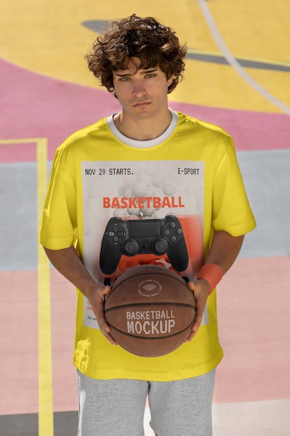 Teenage boy with basketball outside on the court