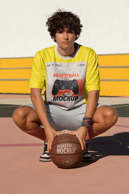 Teenage boy with basketball outside on the court