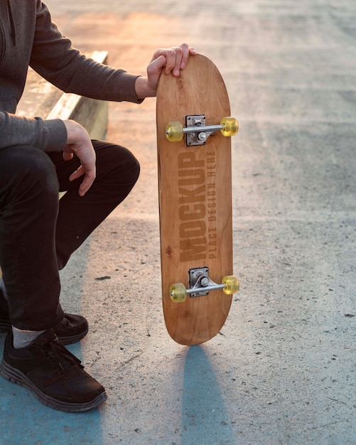 Teenager with mock-up skateboard outdoors