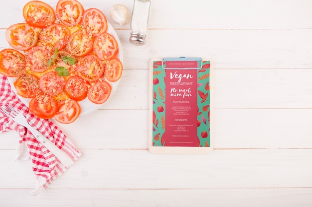 Tomatoes on plate and clipboard