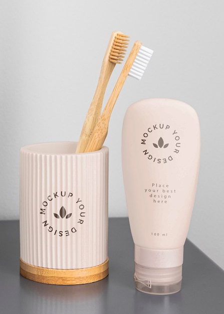 Toothbrushes in cup and cream container