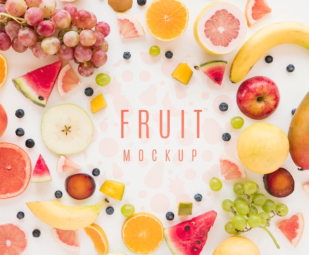 Top view assortment of organic fruits with mock-up