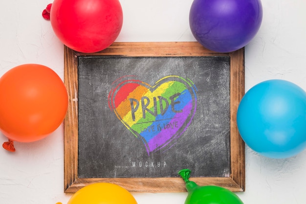 Top view of blackboard with rainbow colored balloons