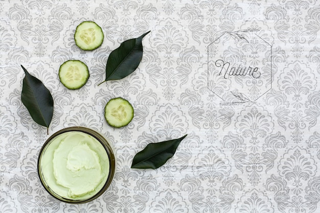 Top view of body butter and cucumber on plain background mock-up