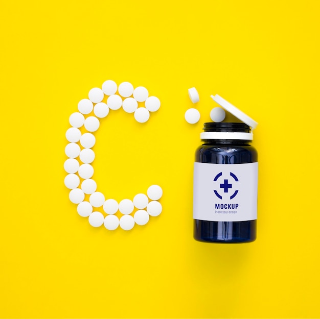 Top view of bottle with pills in shape of c