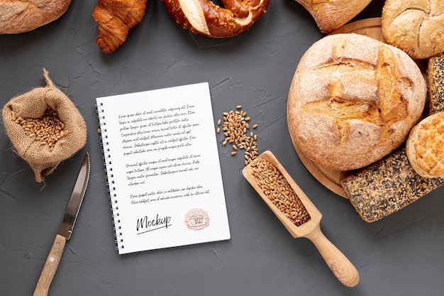 Top view of bread with wheat and notebook