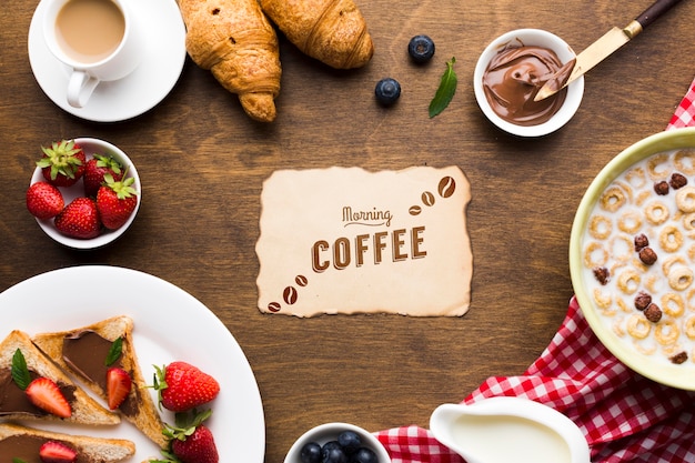 Top view of breakfast food with cereals and fruits and croissants