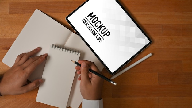 Top view of businessman working with tablet mockup