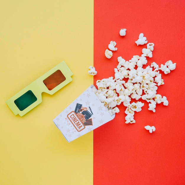 Top view of cinema popcorn in cup with glasses