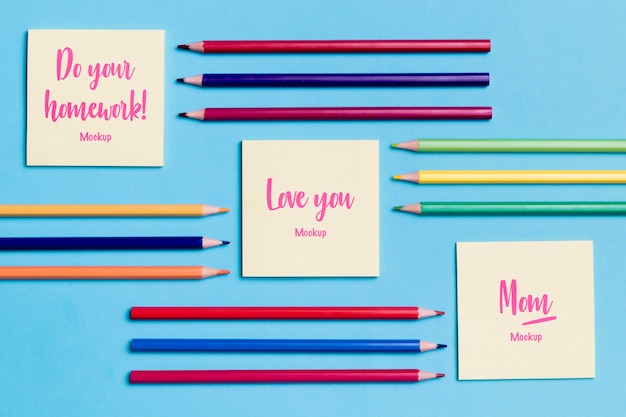 Top view collection of pencils and notes with mock-up