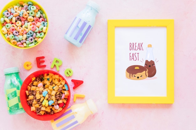 Top view of colorful cereals and frame on plain background