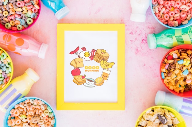 Top view of colorful cereals and frame on plain background