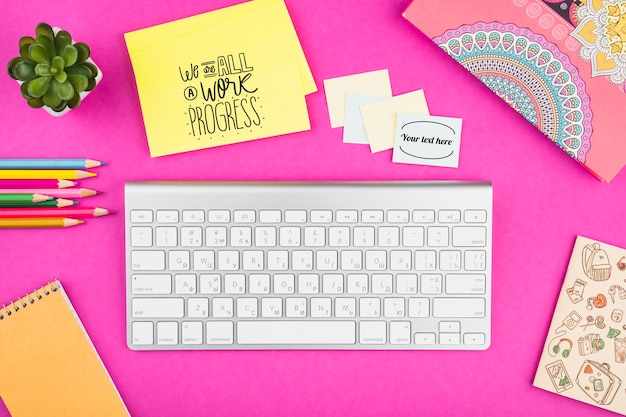 Top view desk concept with pink background