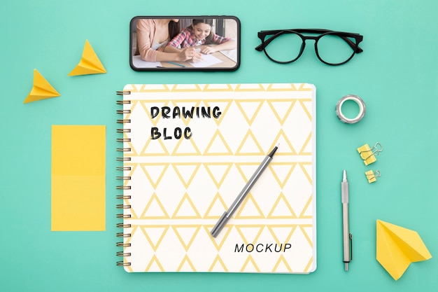 Top view of desk surface with smartphone and pen