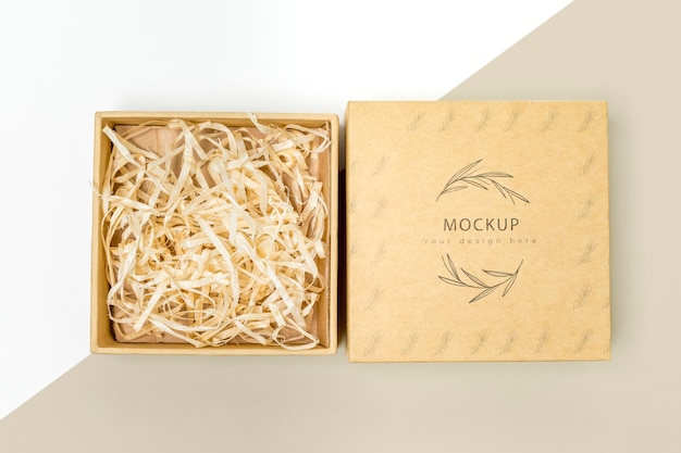 Top view of eco-friendly gift box with shredded paper mock-up