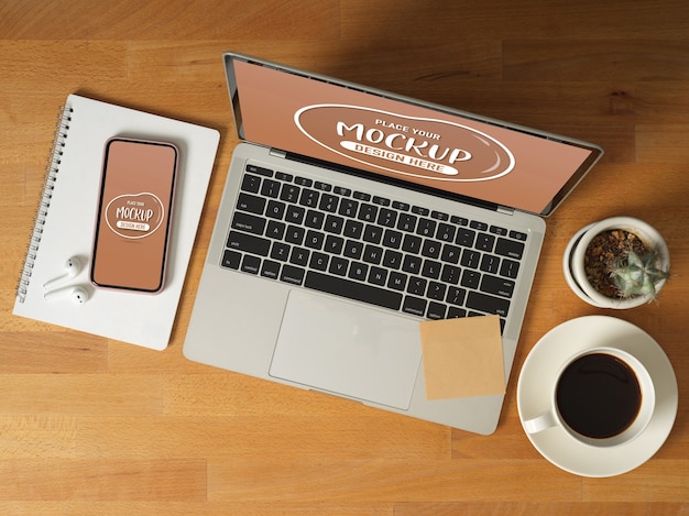 Top view of mock up digital devices with laptop, smartphone, coffee cup, stationery and accessories