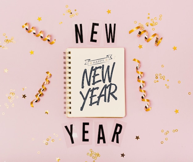 PSD top view new year minimalist lettering on notepad