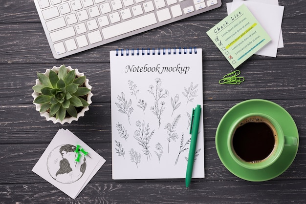 Top view notebook mock-up and stationery near coffee and succulent plant