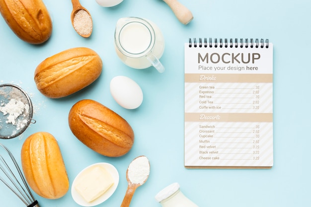 Top view of notebook with bread and ingredients