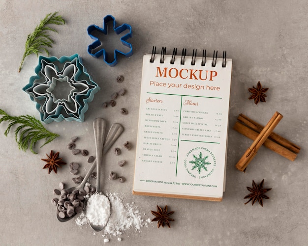 Top view of notebook with snowflake forms and cinnamon