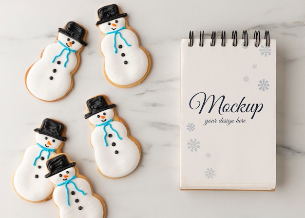 Top view of notebook with snowman cookies