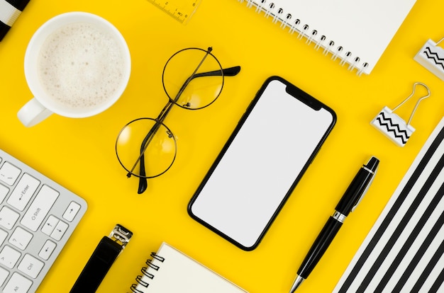 Top view phone mock-up with glasses and cup