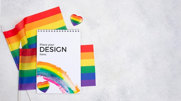 Top view of rainbow flags and notebook