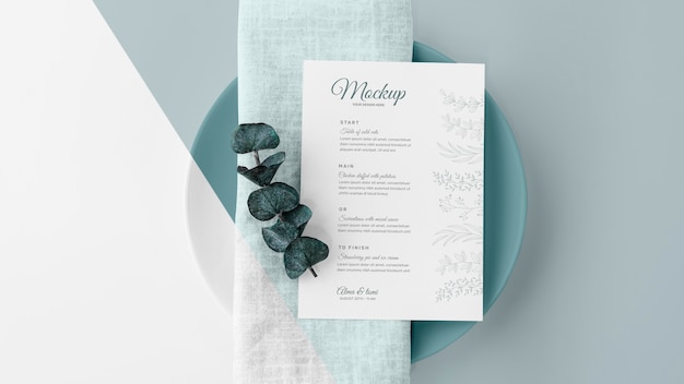 Top view of table arrangement with spring menu mock-up and leaves