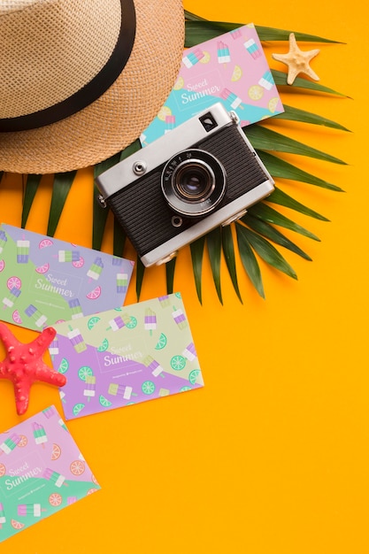 Top view travel hat with summer cards and camera