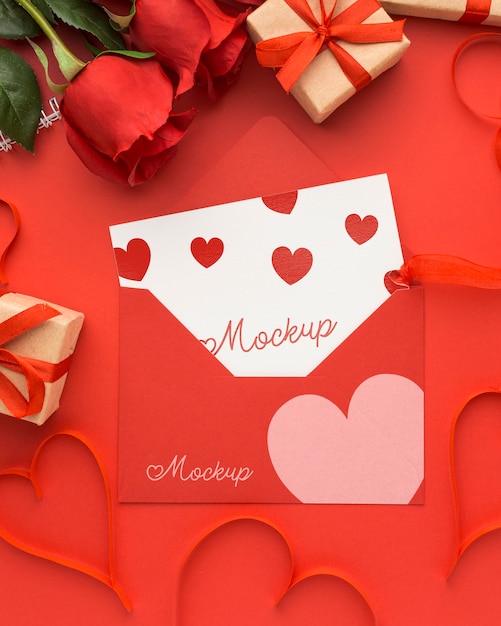 Top view valentine's day gifts and roses with mock-up letter