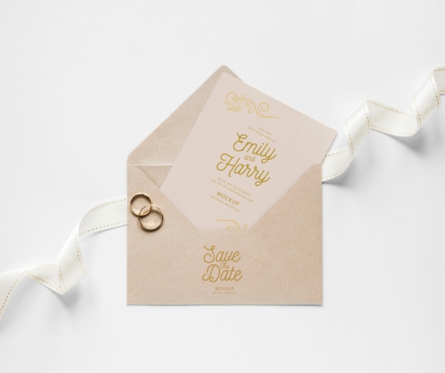 Top view of wedding card with envelope and rings