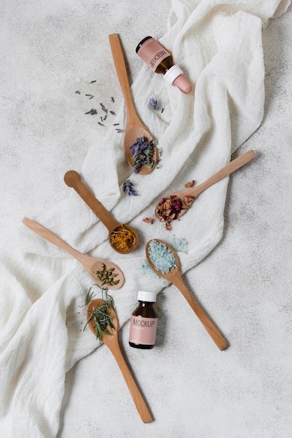 Top view wooden spoons with petal flowers