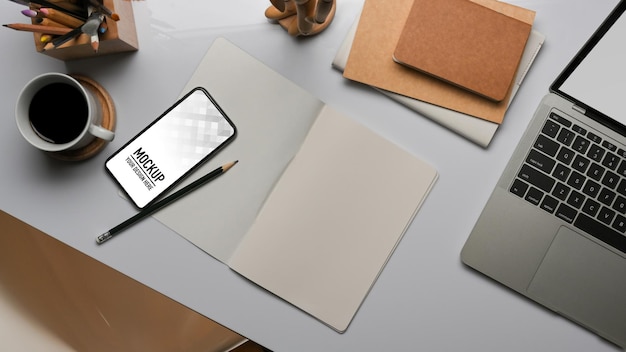 Top view of workspace with smartphone mockup