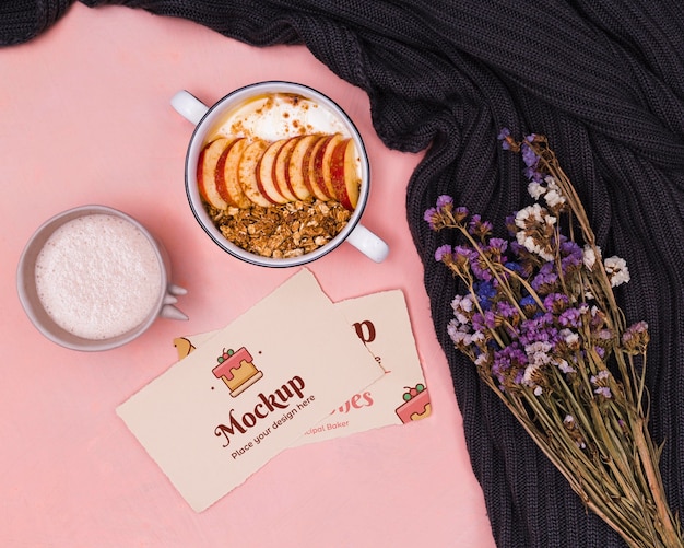 Top view yogurt and fruits with cardboard mock-up and dead flowers